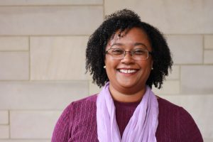 Dr. Sharlene Newman standing in front of a building.