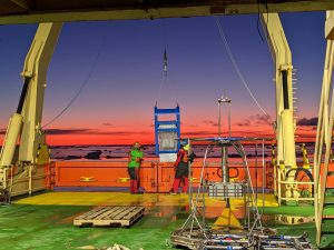 Photo of MTs Matt Louis and Hila Shooter deploying the epibenthic sledge nicknamed 'baby blue' at sunrise