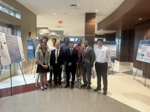 REU students presenting their research posters during the Capstone event at the end of the 10-week program.