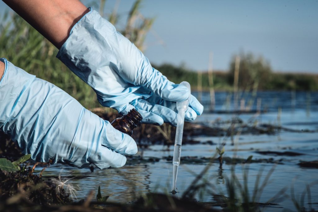 Water scientist pulling samples from a stream.