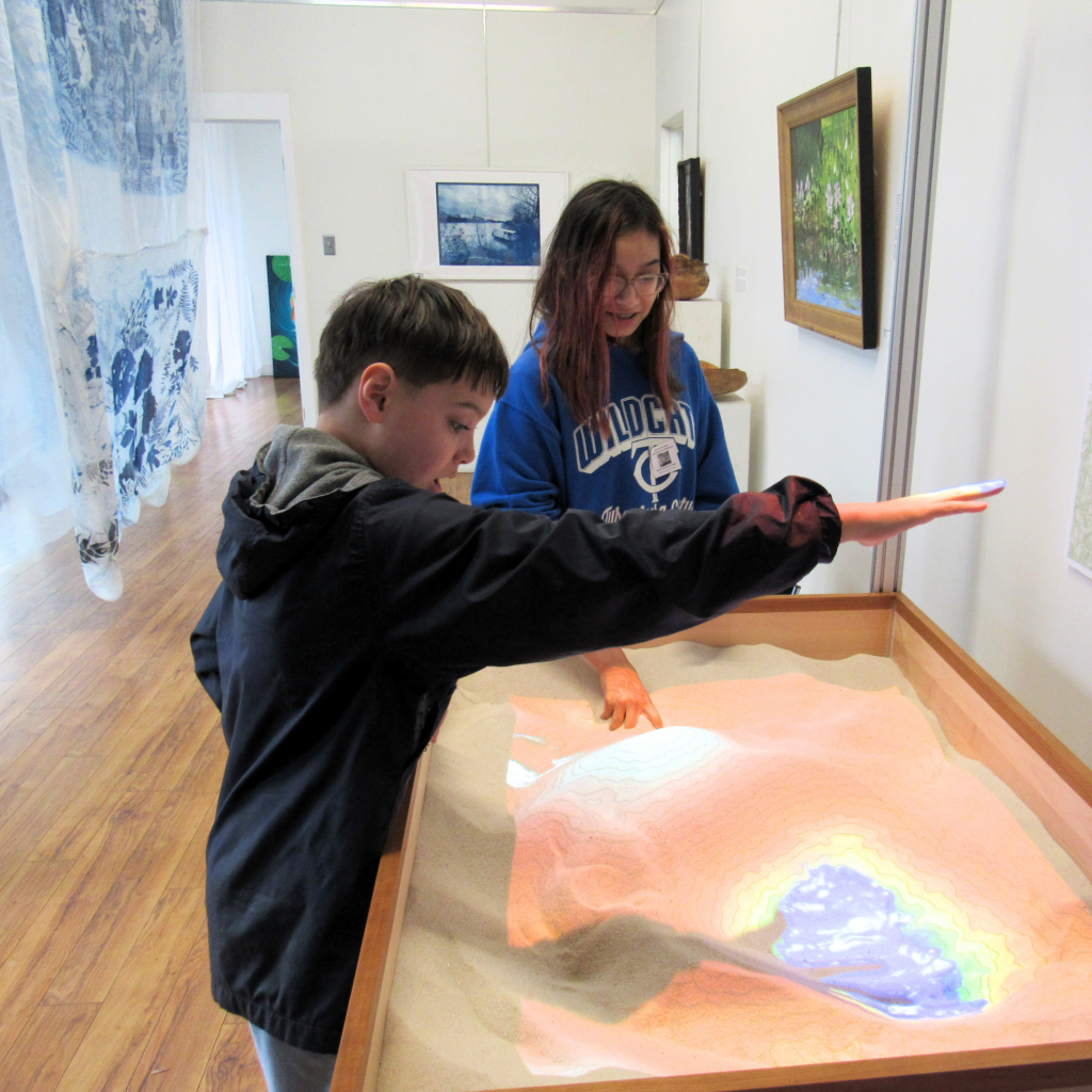 Elementary students working with TopoBox to help them understand complex water science topics.