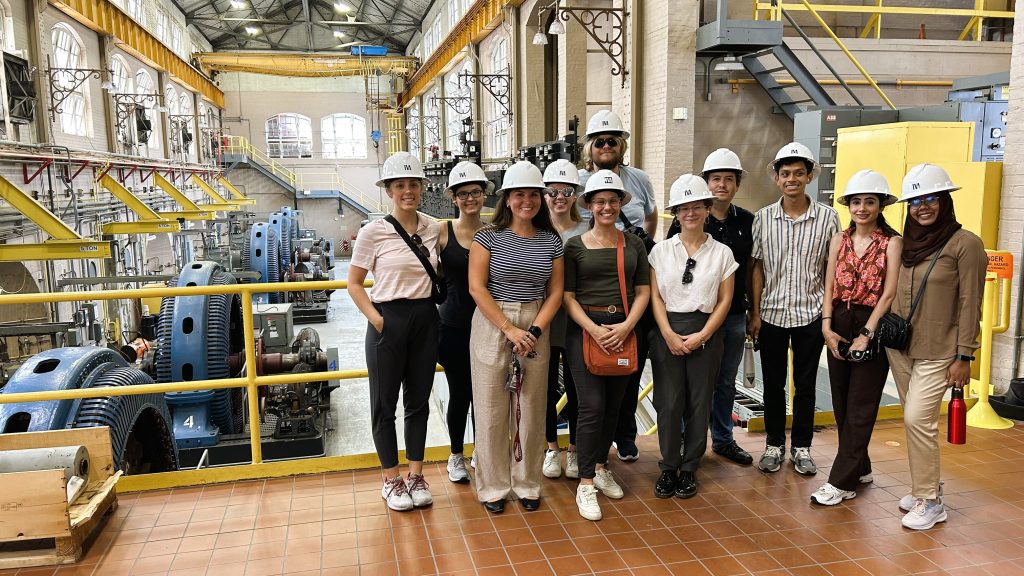 Graduate students wear hard hats while touring water forecasting facilities as part of the Water-R20 NRT program's hands-on learning experience.