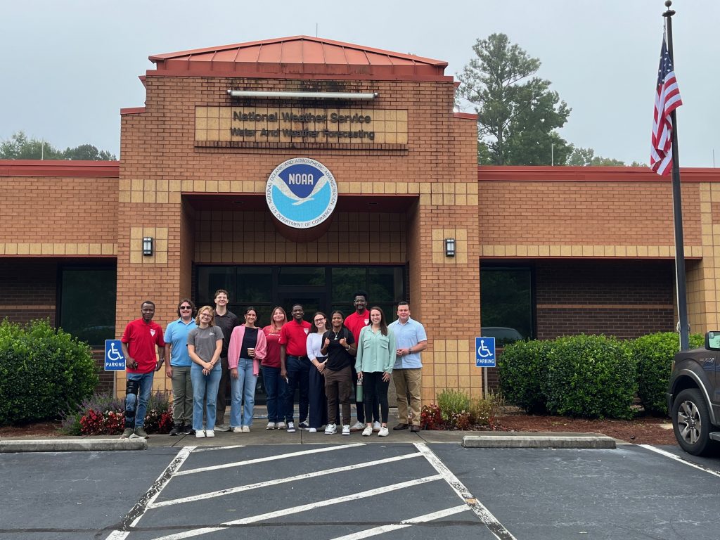 A group stands in front of the National Weather Service Southeast River Forecast Center building.