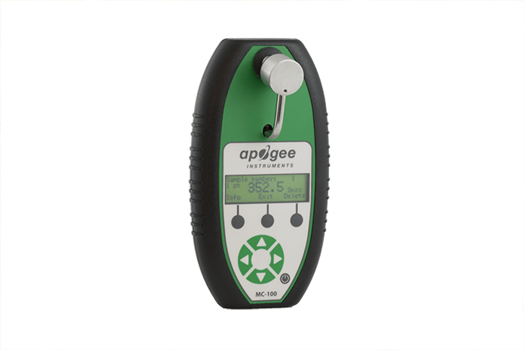 Apogee MC-100 chlorophyll concentration meter with green and black casing, small display screen, and clamp sensor for analyzing plant chlorophyll levels.