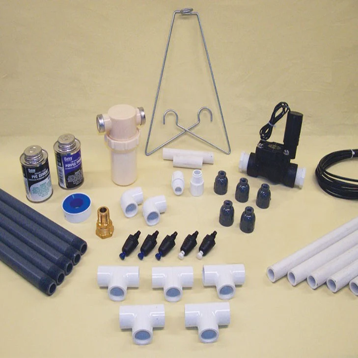 Phytotronics mist and watering kit components, including PVC pipes, fittings, valves, tubing, and connectors, used to maintain consistent moisture for plant propagation.