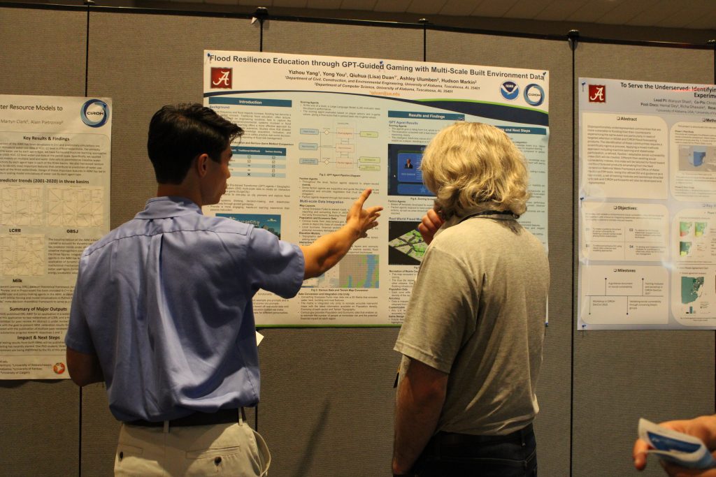 People in a conference hall gathered in front of research posters and engaged in discussion.