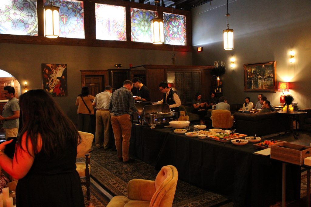 Networking event attendees gathering for food, chatting and more, with guest appearance from Big Al.