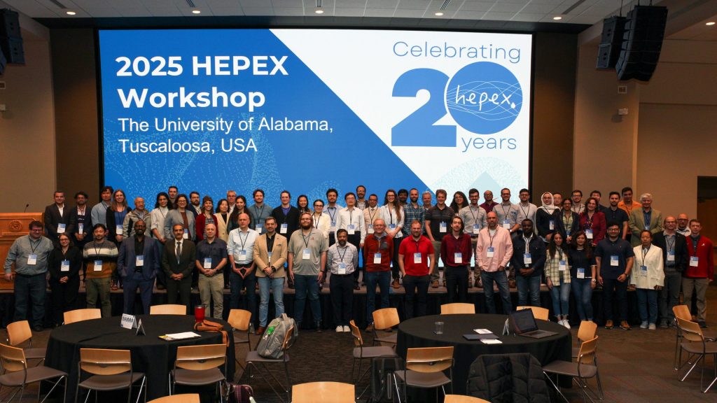 Group of people standing in front of a presentation screen.