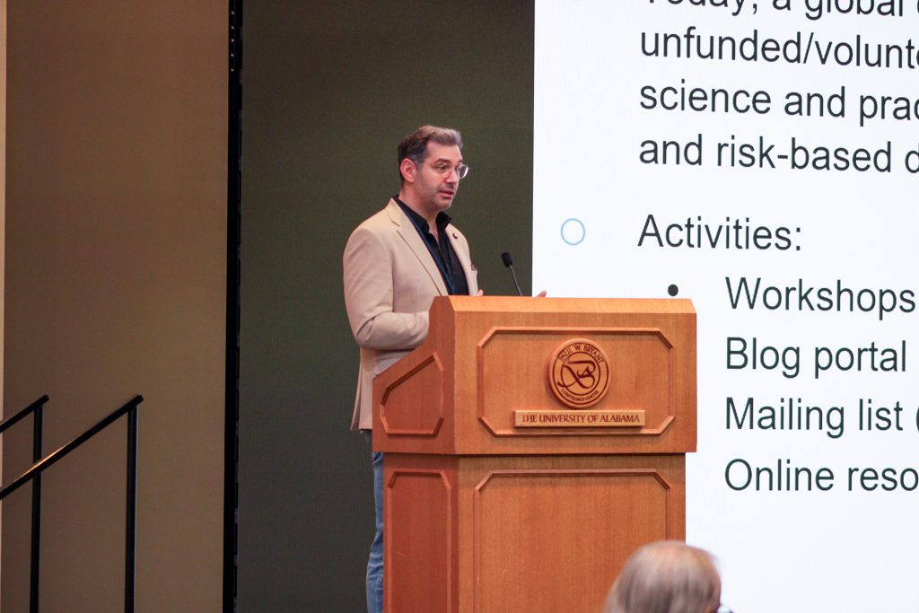 Man behind podium delivering presentation.