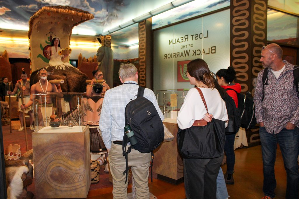 People looking at museum artifacts.