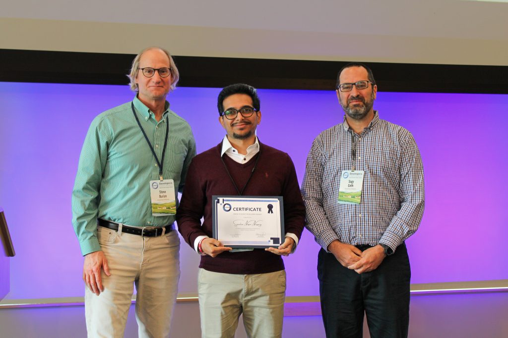 Savalan Naser Neisary, center, holds his Student Developer Award certificate while standing with Steve Burian, left, and Sagy Cohen, right.