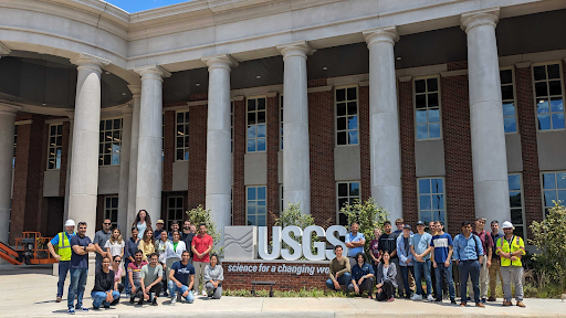 Students in the summer institute program in front of the USGS sign